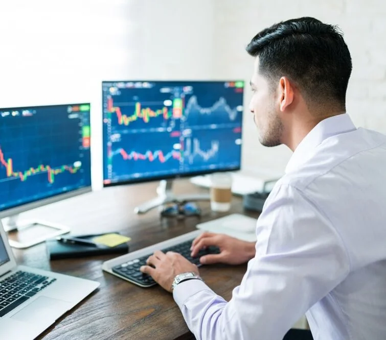 A man at a computer analyzing graphs